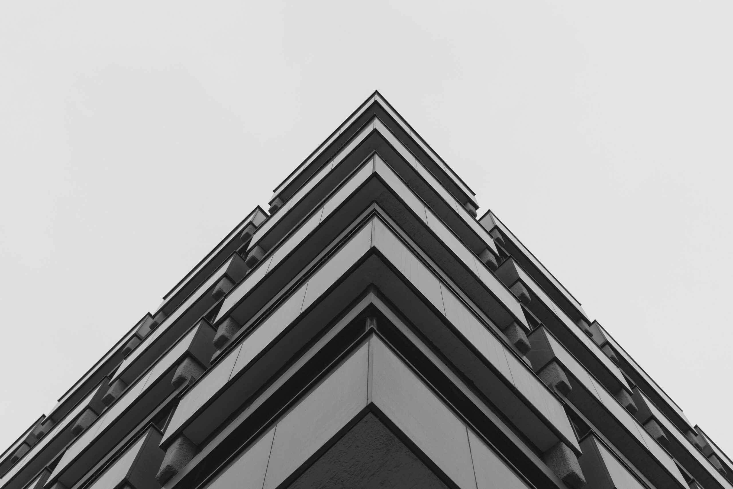 A low angle shot of a grey concrete building representing modern architecture